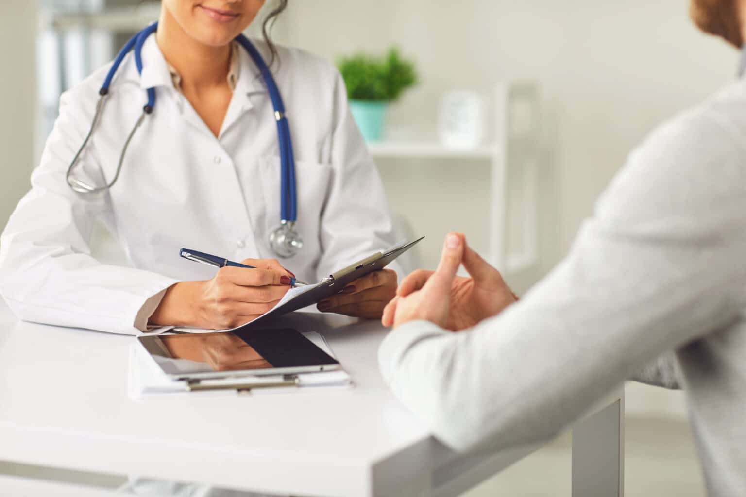 Doctor speaks with patient to explore diagnosis.