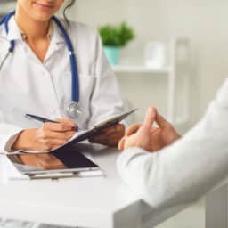 Doctor speaks with patient to explore diagnosis.