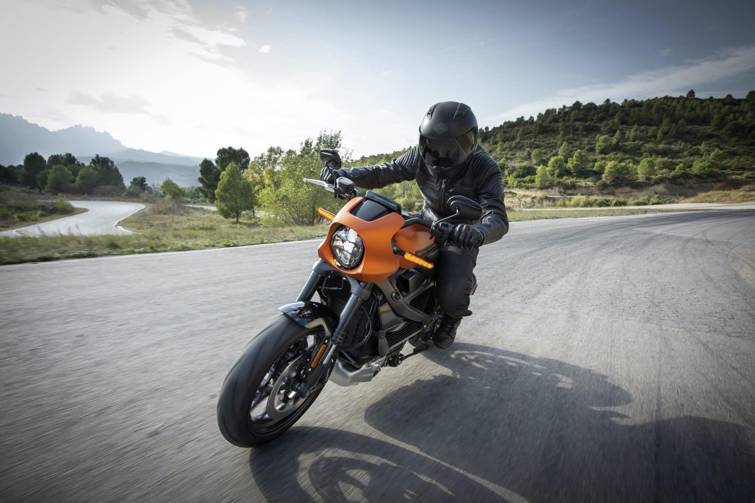 Man riding his motorcycle on the open road.