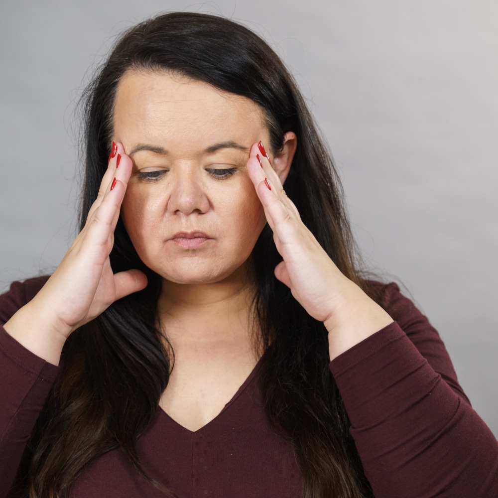 a woman puts her head in her hands