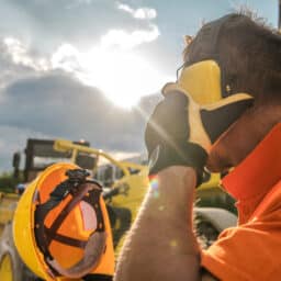 Man wearing earmuffs at a construction site