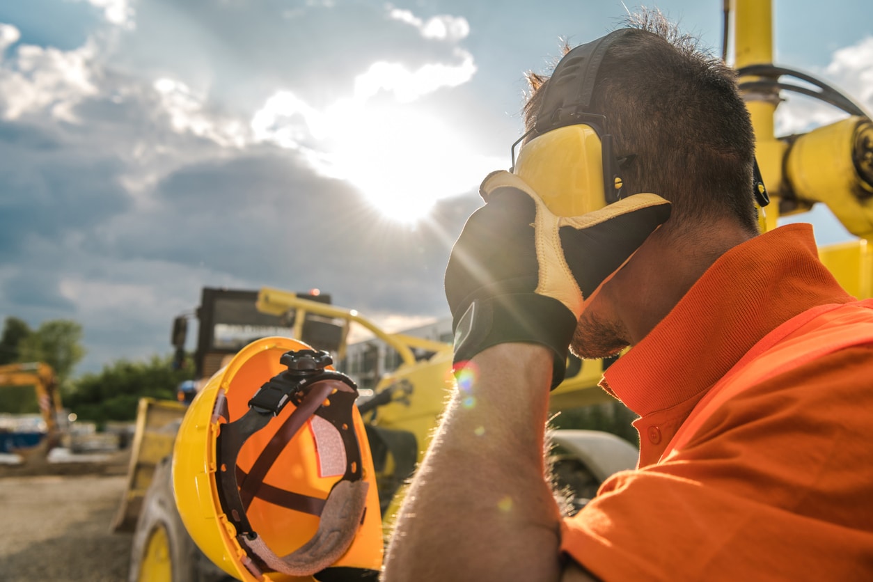 Man wearing earmuffs at a construction site