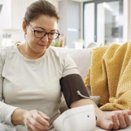 Close up of woman checking her own blood pressure