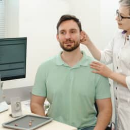 Audiologist and patient discussing hearing aid options for tinnitus