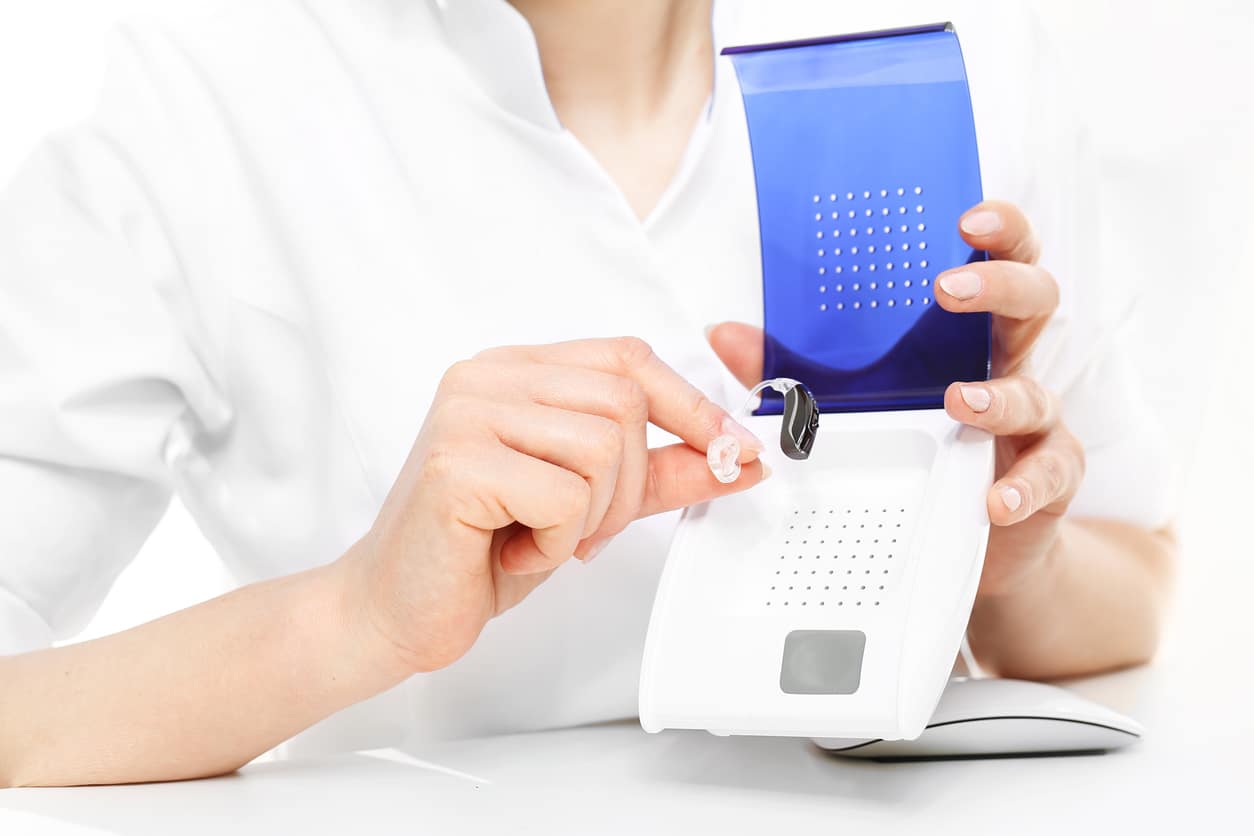 Audiologist showing a hearing aid dryer.