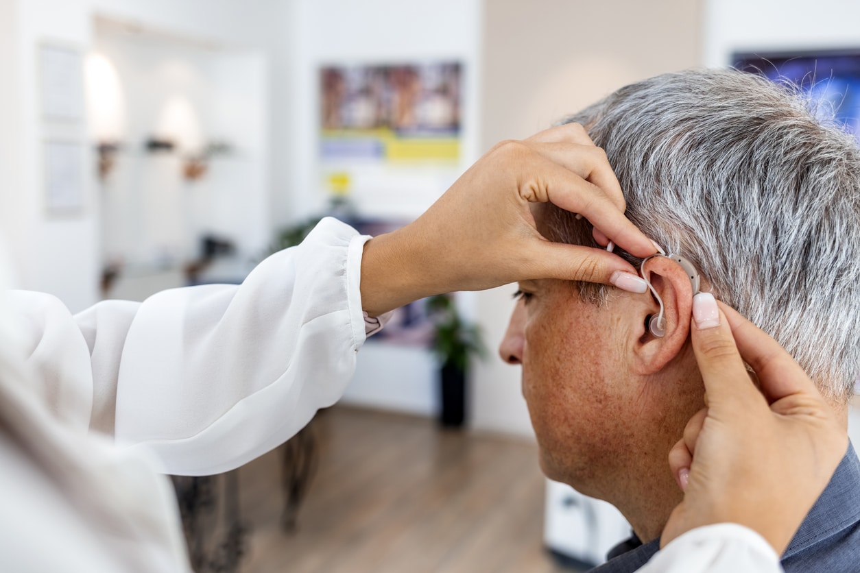 Man is fitted for hearing aid