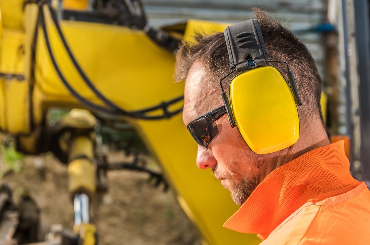 Man wears hearing protection at work